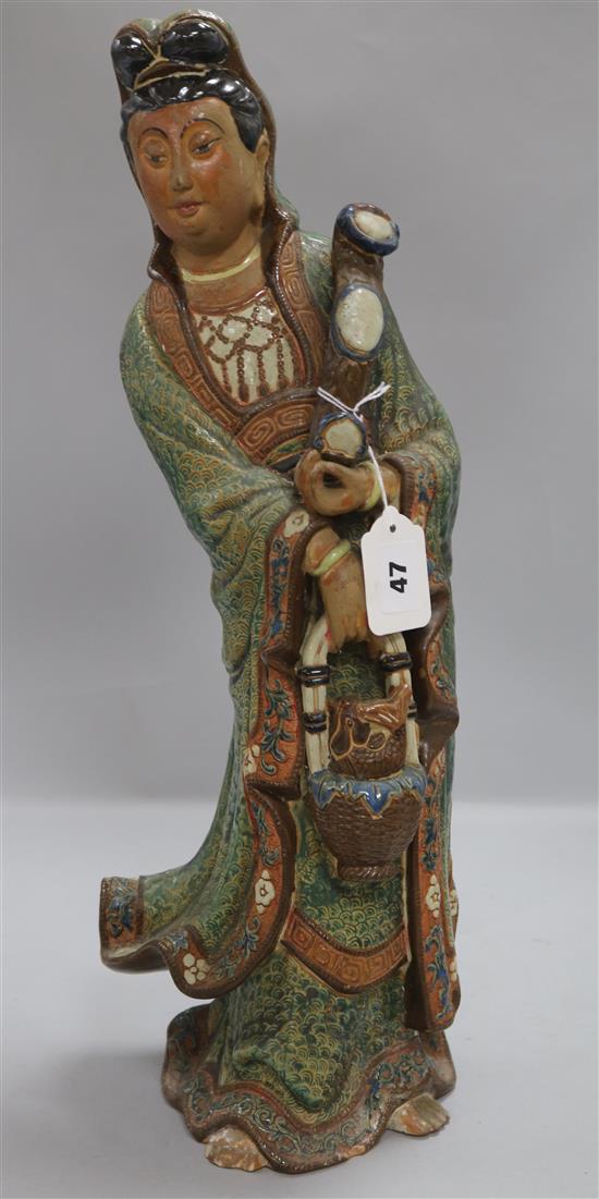 A Chinese polychrome-glazed terracotta figure of Guanyin, H approx 21in (54cm)